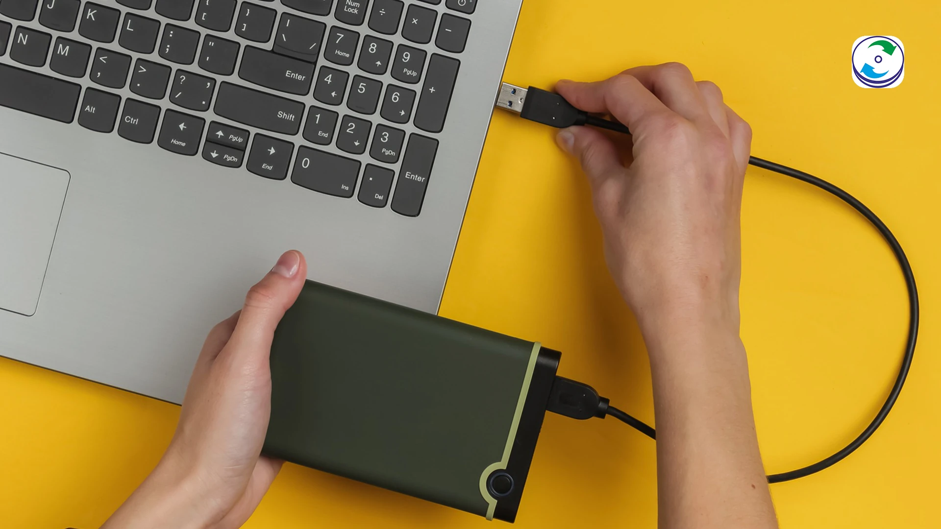 A hand unplugging a USB cable from a stylized, flashing external hard drive, symbolizing the frustrating experience of an external drive repeatedly disconnecting and the need to stop all activity.