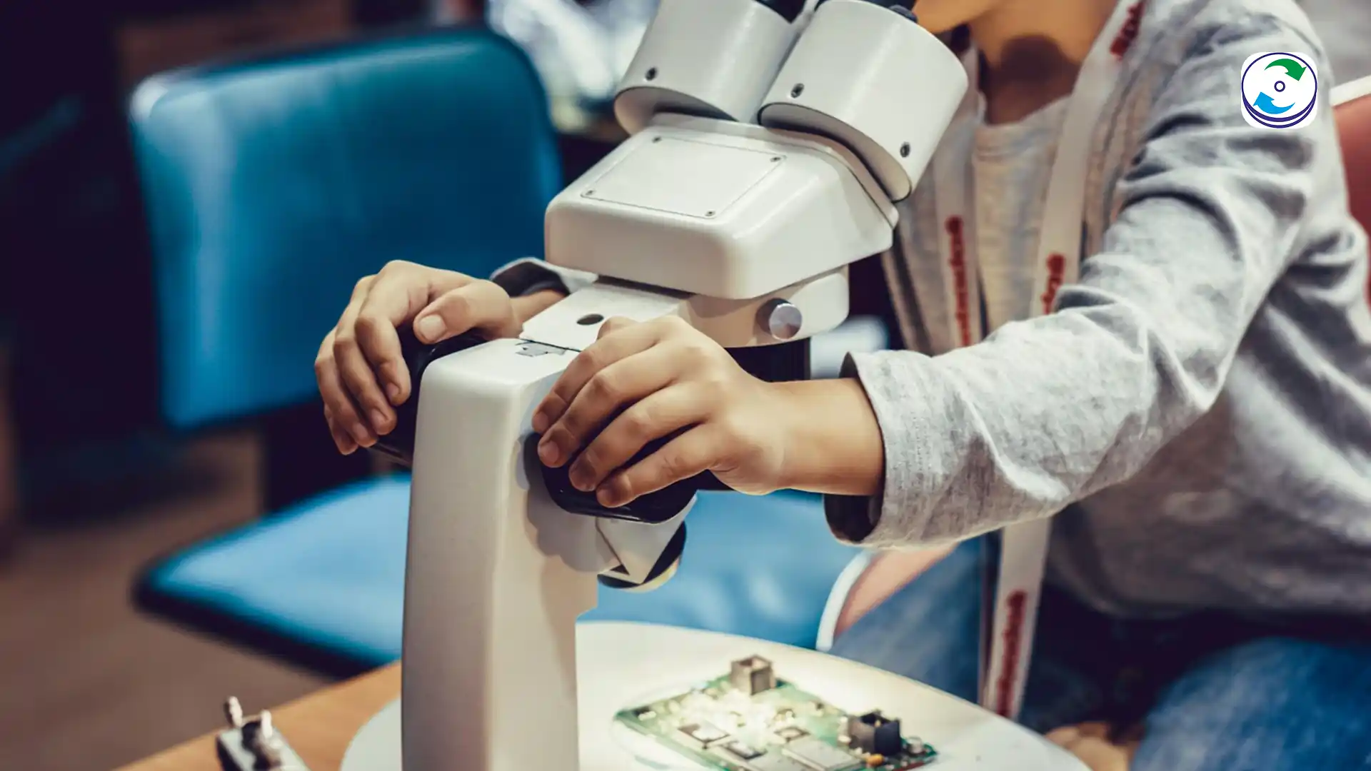 A close-up photograph of a technician using a micro-soldering iron and flux to carefully remove a tiny surface-mount chip from a hard drive PCB under a microscope.