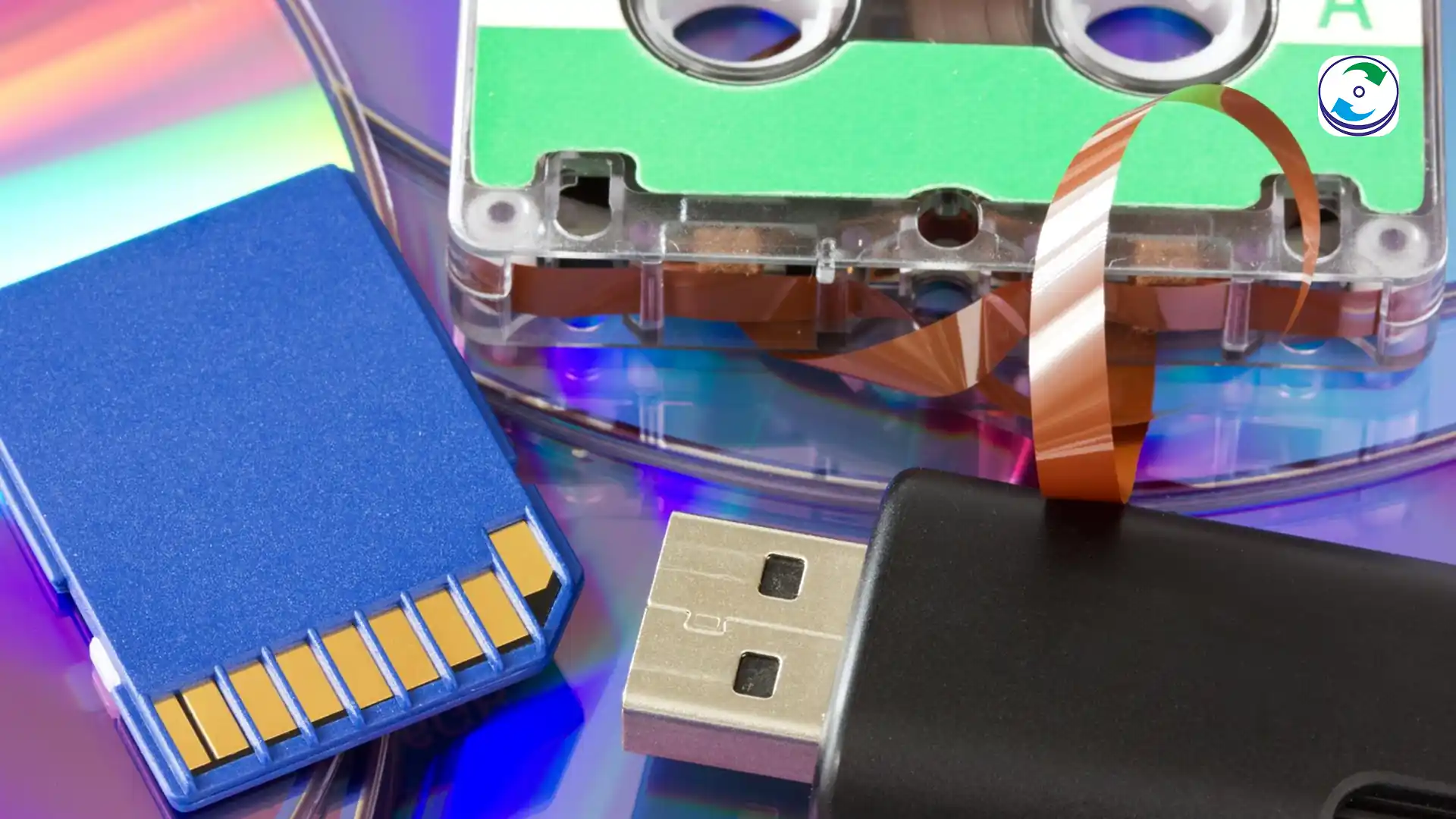 A side-by-side comparison of a metallic hard disk platter, a small flash memory chip (representing an SSD), and a modern LTO tape cartridge, emphasizing the three different forms of digital media storage.