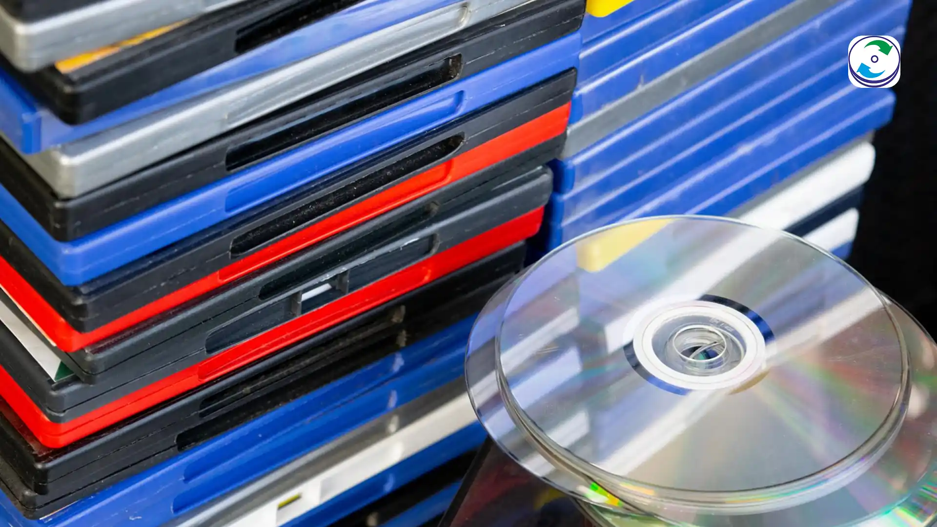 A collection of obsolete digital storage media, including a ZIP disk, a floppy disk, and a scratched optical disc.
