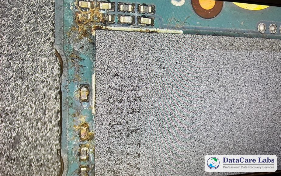 Tea residue and corrosion on a Samsung 980 SSD board Liquid damaged SSD recovery after tea spilled on a laptop: dried residue and a corroded capacitor on the Samsung 980 board