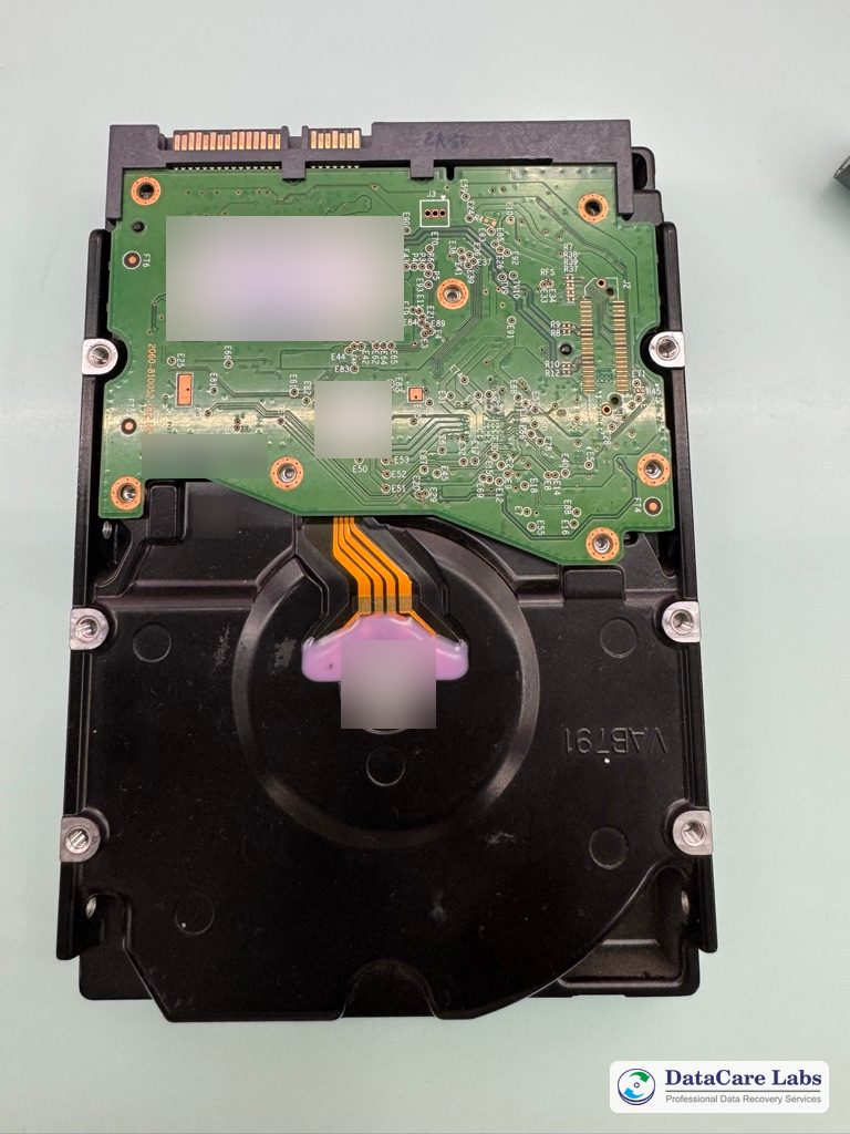 WD 8TB hard drive, circuit board side, before the clean-room head replacement WD 8TB hard drive with hard drive head failure after a drop: circuit board side before the clean-room repair